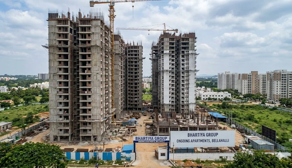 Construction progress of ongoing residential apartment projects in Bellahalli near Thanisandra Main Road and Bhartiya City.